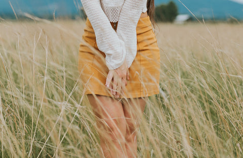 female in skirt covering her thighs