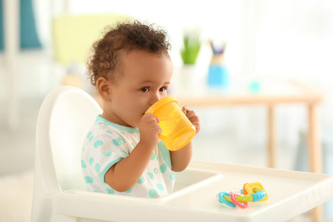 toddler drinking from a sippy cup