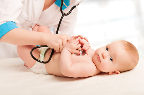 doctor checking baby for cough