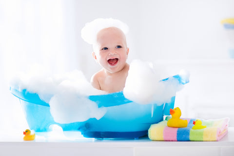 baby in baby bath tub for bubble bath