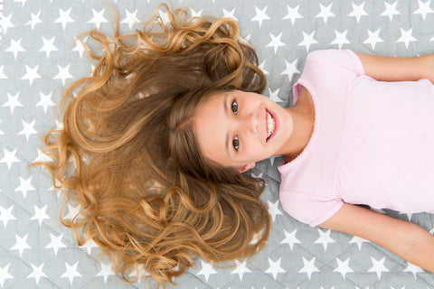 kid laying down with detangled hair