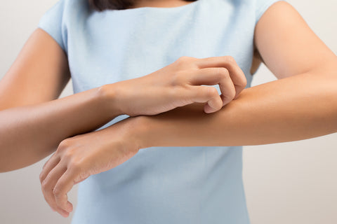 woman scratching itchy sensitive skin