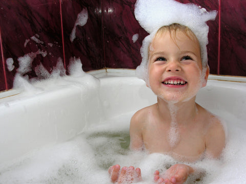 toddler taking a bath during toddler bedtime routine
