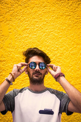 Sun heat wave UV rays yellow background boy in sunglasses