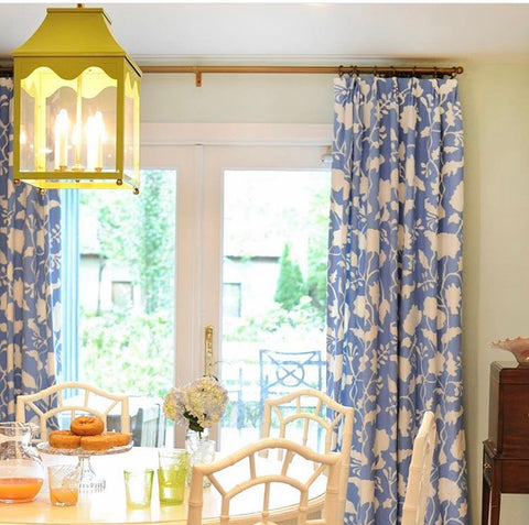 A dining room with an elegant dining table and high end lighting.