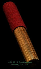 wooden mallet with red suede cover black background