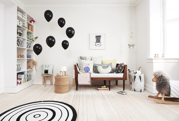 Scandinavian inspired nursery with stylish furniture and home accessories. A neutral colour scheme with monochrome accents creates a design-led environment inspiring creative play.