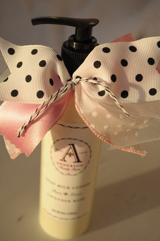 Organic natural lavender rose goat milk lotion bottle with pink and white polka dot ribbon