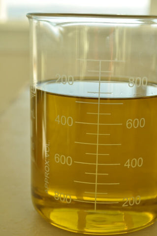 golden organic shea butter in a glass beaker