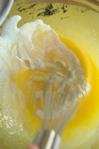 Whisking eggs and sugar in saucepan