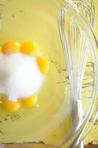Egg yolks in bowl with sugar