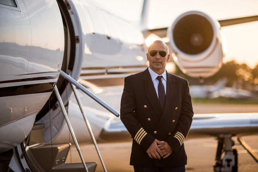 Private Jet Pilot standing with jet
