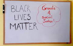 Office white board saying 'Black Lives Matter' and 'Granola 4 Social Justice'