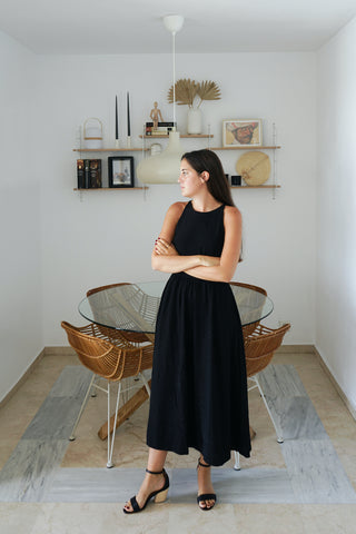 Laura Egea standing with crossed arms in a dining room. 