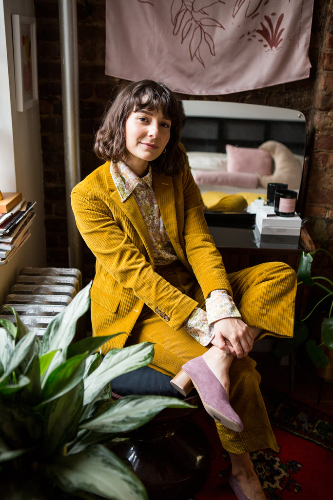 Alyssa Coscarelli, a freelance fashion writer, consultant, and influencer seated wearing the Narwhal Heel.  