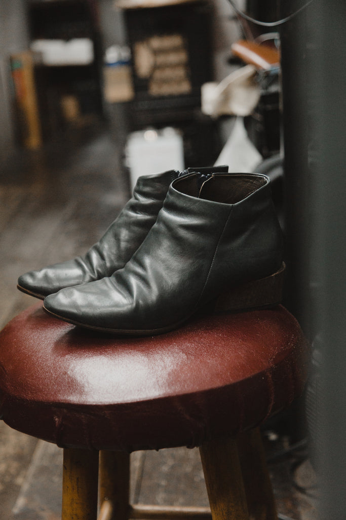 Image of a pair of Coclico shoes on a stool in the Cowboy Shoe Repair shop. 