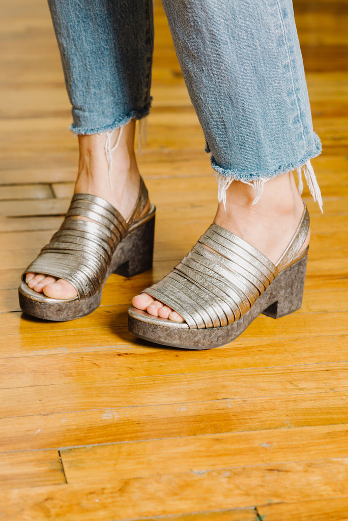 Close up of Emily Aumiller in her Coclico Mosh Wedge in Nickel Metallic leather.