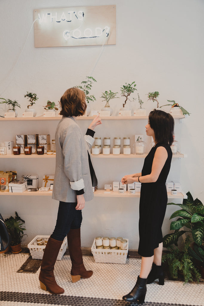 Robin Reetz and Rosa Ng looking at the products on the Good Goods shelves. 