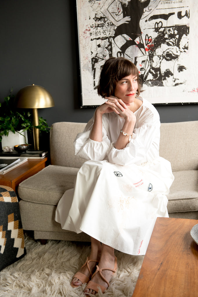 Gretchen Jones seated on the couch in her Coclico Oasis sandals.