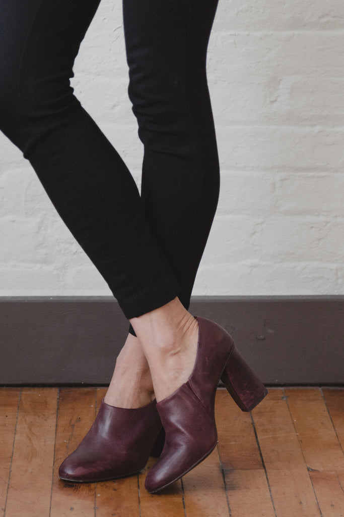 Close up image of Julie Resnick standing with crossed ankles in the Chenoa Heel.