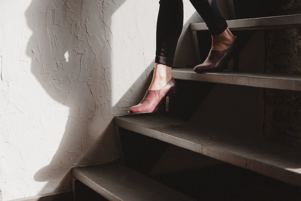 Close up of Julie Resnick walking down the stairs in the Chenoa Heel in Chianti Leather.