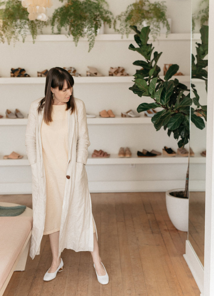 Umeboshi's owner Stephanie Gorrell, standing in front of a mirror checking out her Coclico heels. 