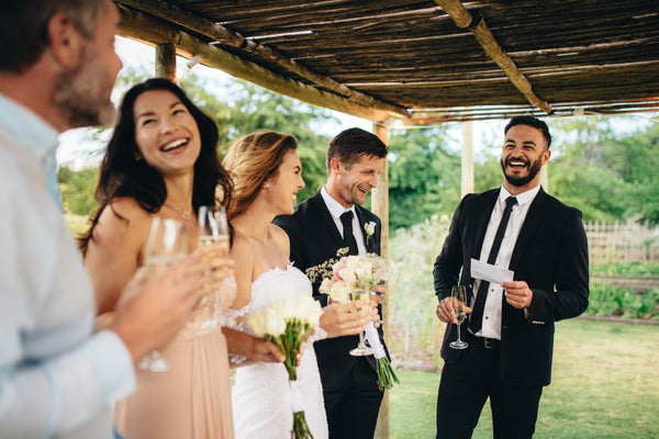 best man giving speech to newly wedded couple at wedding reception - best man tips