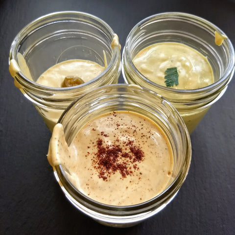 three jars of three flavors of copycat bitchin sauce almond vegan plant based dairy free cheese dips chipotle, herbed, nacho jalapeno recipe by Urban Cheesecraft