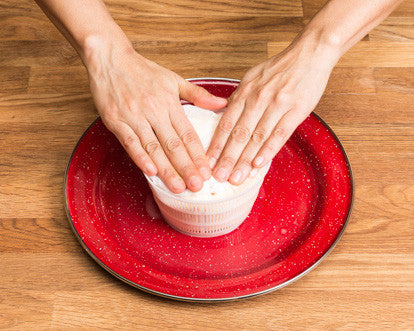 Urban Cheesecraft packing curd into mold shaping for a wheel of queso blanco