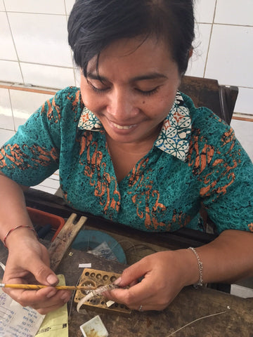 Love Is Project artisan in bali making the love bracelets  