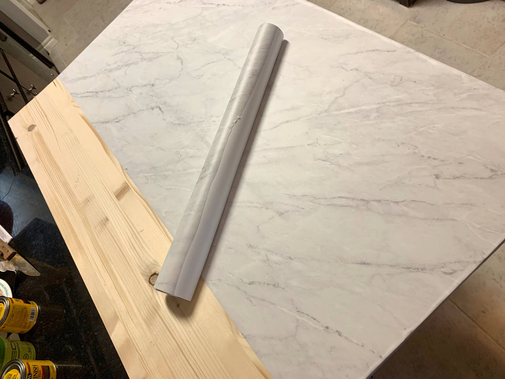 Applying marble contact paper to wood