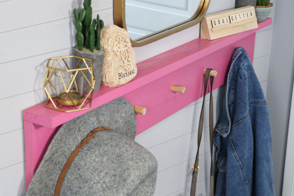 DIY Pink Wall Coat Rack with hat, jacket and purse hanging 