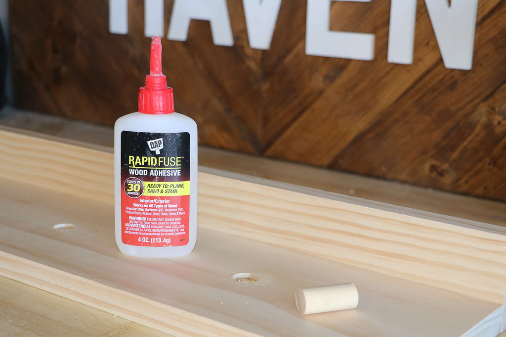 DAP Rapid Fuse Glue and Wooden dowel sitting on top of a select pine board