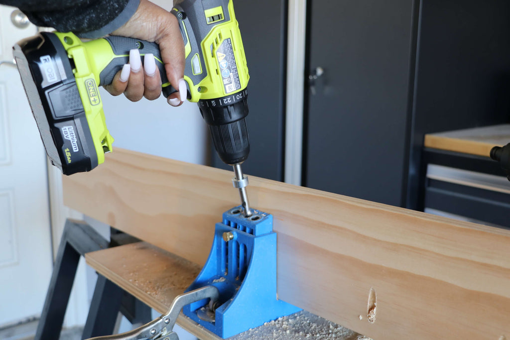 Ryobi Drill/Driver drilling pocket holes into a select pine board using a Kreg Jig