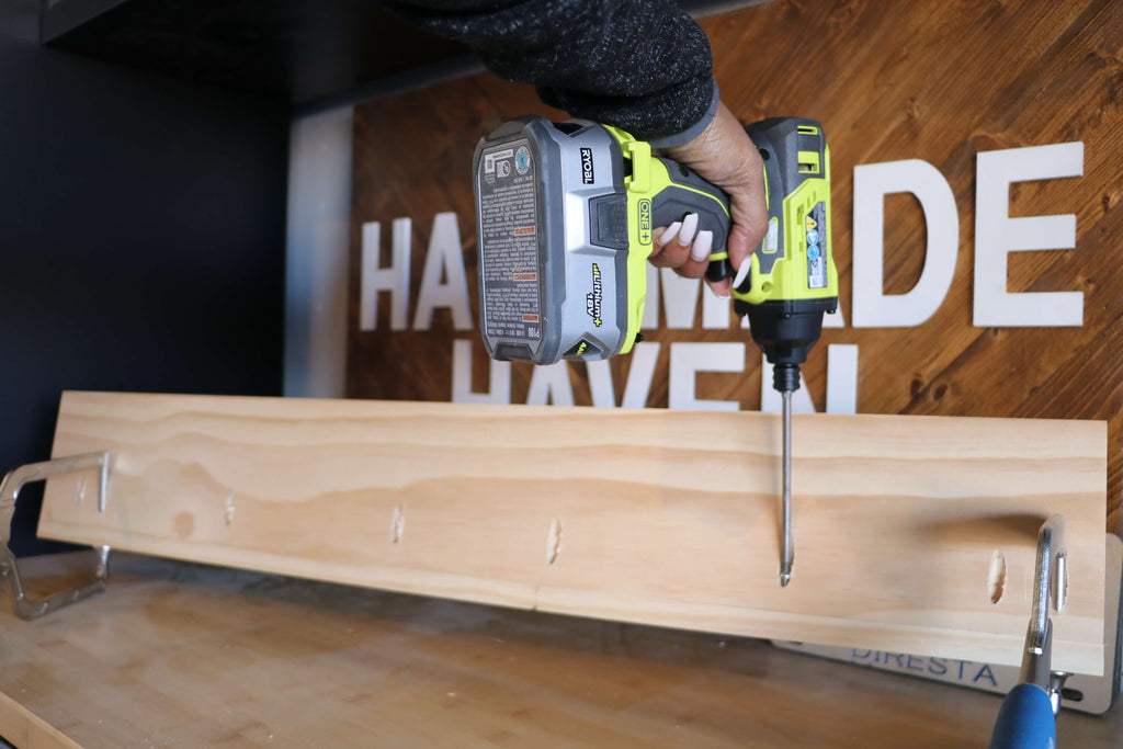 Ryobi Impact Driver drilling in pocket hole screws into a pine board