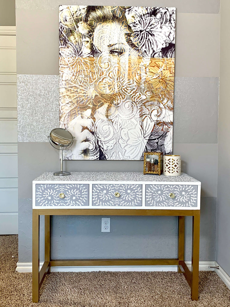 Vanity Desk with Stenciled Design and Gold Legs under a Oliver Gal Art Piece