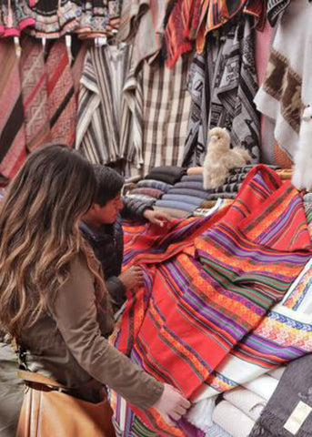 Sourcing textiles at a market in Cusco, Peru