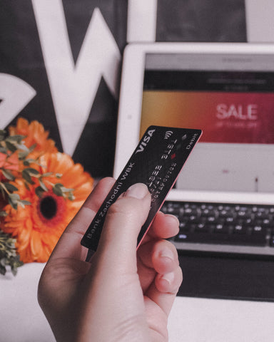 Shopping online during a sale while using a credit card. Photo taken by ostshem on unsplash.