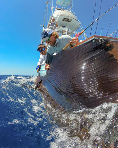 Two fisherman offshore fishing on a boat picture by Gabe Nyblad