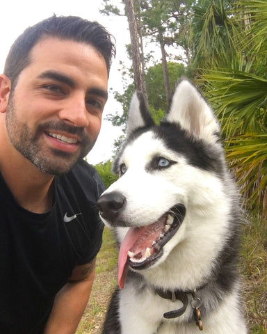 Fuse founder Jon with husky dog Brody in front of Florida palms