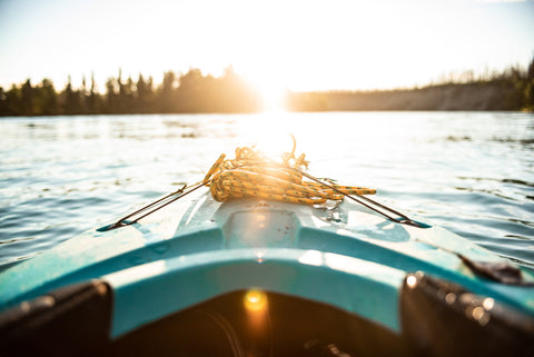 Blue kayak facing sun during golden hour