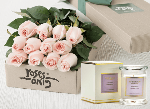 Pastel pink roses and candle