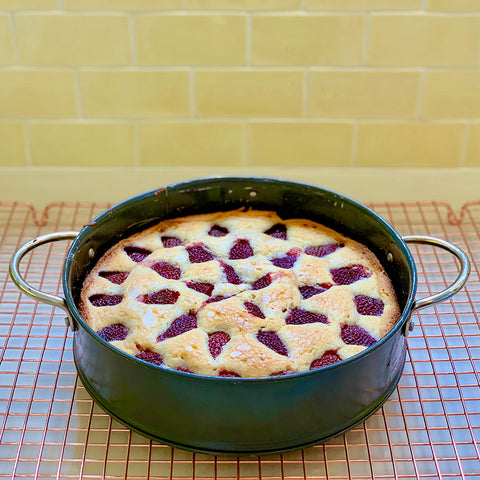 baked strawberry buttermilk cake cooling on rack