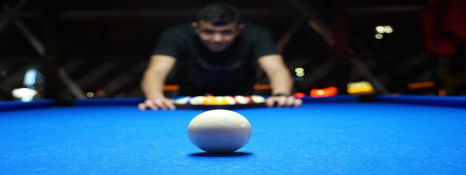 image of a pool player over table - absolute cues