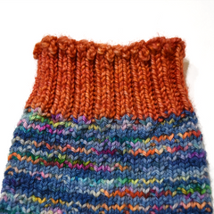 Hand knitted sock orange ribbed cuff using Jeny's Surprisingly Stretchy Bind Off