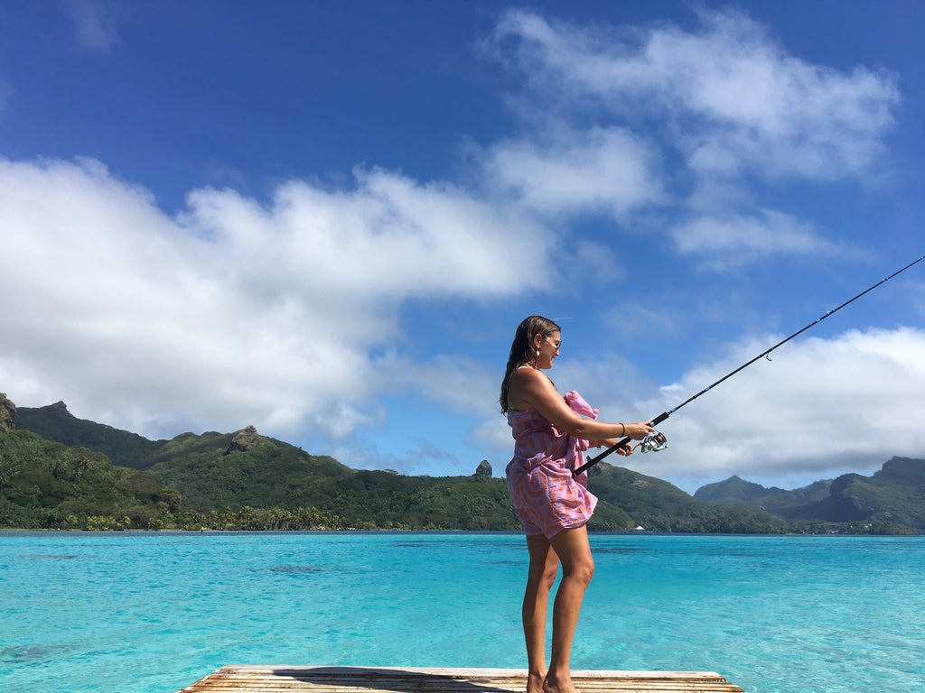 Melissa fishing of the dock on Huahine