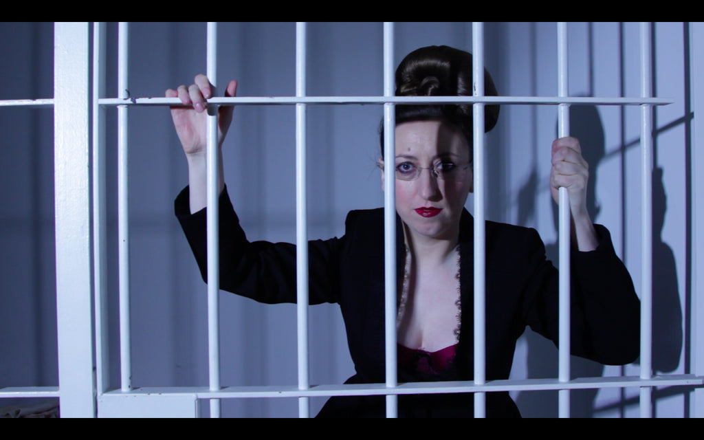 Catherine (the founder of Kiss Me Deadly) appears to be behind bars