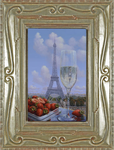 A Glass of Champagne and strawberries with the view of the Eiffel Tower and blue skies in the background. 