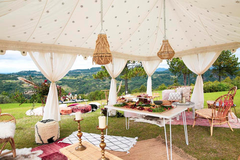 luxury wedding setup in a tent with cushions and rugs