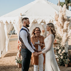 bride and groom ceremony and celebrant standing in front of a luxury marquee from exotic soirees hire on the gold coast